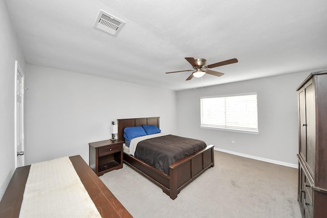 bedroom with ceiling fan and light carpet