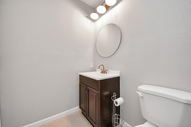 bathroom featuring toilet, vanity, and tile patterned flooring