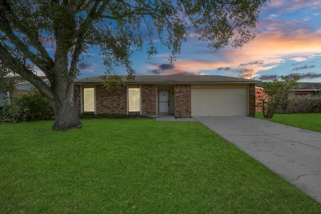 single story home with a garage and a lawn