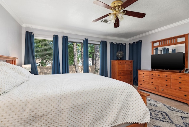 bedroom featuring carpet floors, ceiling fan, a textured ceiling, and crown molding