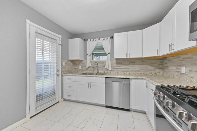 kitchen featuring sink, white cabinets, and appliances with stainless steel finishes