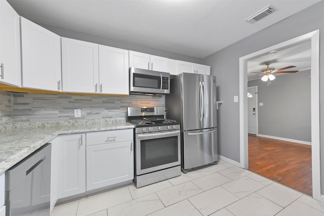 kitchen featuring appliances with stainless steel finishes, ceiling fan, and white cabinetry