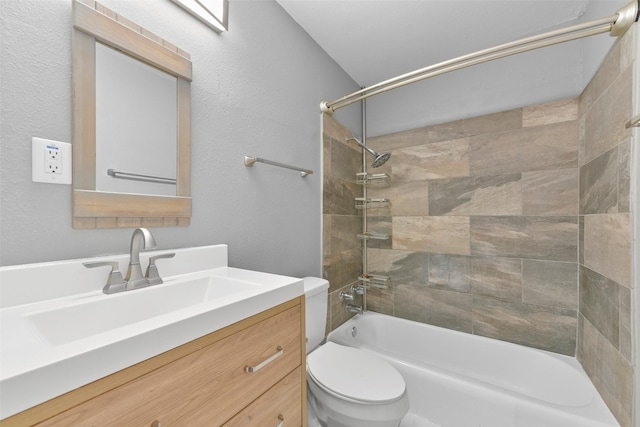 full bathroom featuring toilet, vanity, and tiled shower / bath