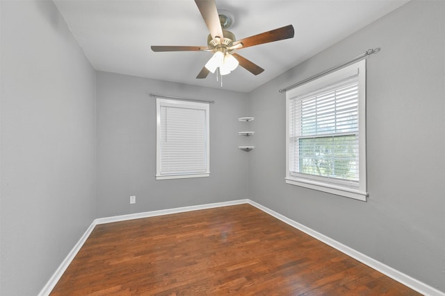 spare room featuring ceiling fan and dark wood-type flooring