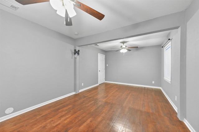 unfurnished room featuring ceiling fan and dark hardwood / wood-style flooring