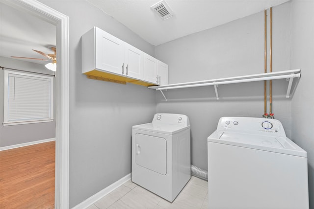 laundry area featuring washing machine and clothes dryer, ceiling fan, and cabinets