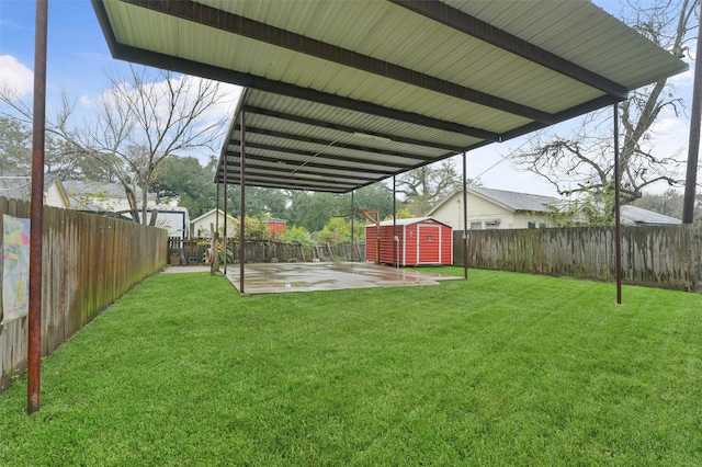 view of yard featuring a patio and a shed