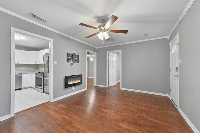 unfurnished living room featuring ceiling fan, crown molding, and light hardwood / wood-style floors