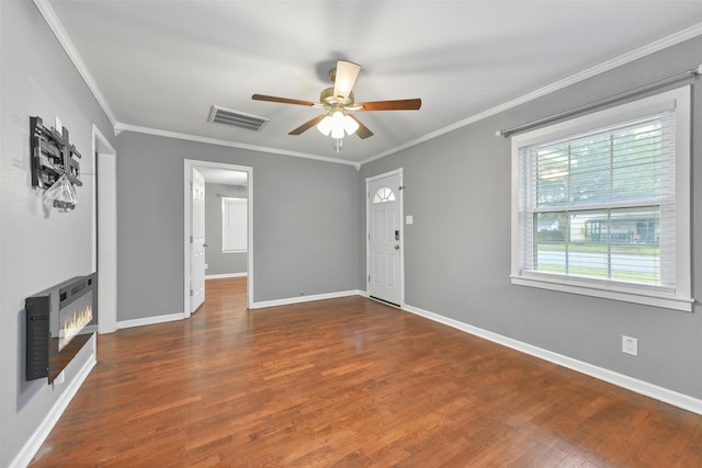 unfurnished living room featuring ornamental molding, ceiling fan, and dark hardwood / wood-style floors