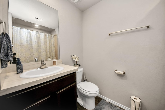 bathroom featuring vanity and toilet