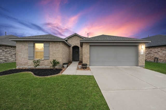 single story home with a lawn and a garage