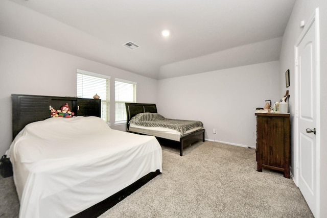 bedroom with lofted ceiling and light carpet