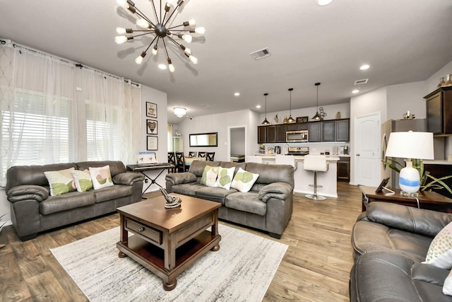 living room featuring a notable chandelier and hardwood / wood-style floors