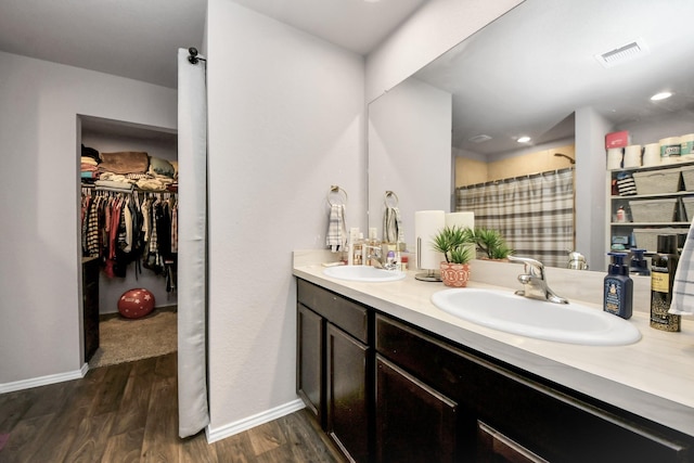 bathroom with a shower with curtain, vanity, and wood-type flooring