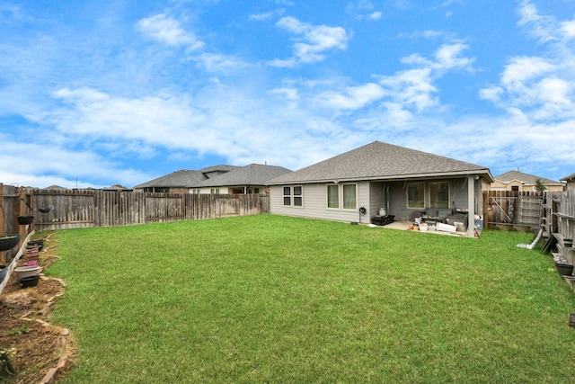 back of house with a patio and a lawn