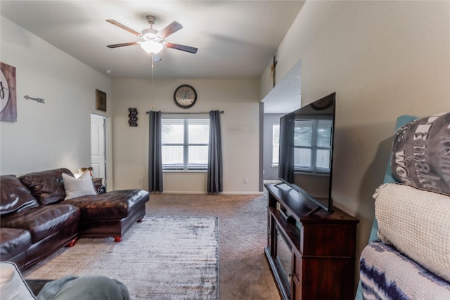 carpeted living room with ceiling fan