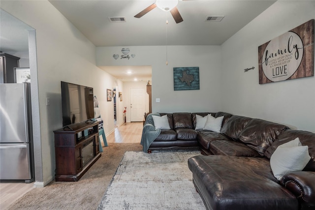 living room featuring ceiling fan and light carpet