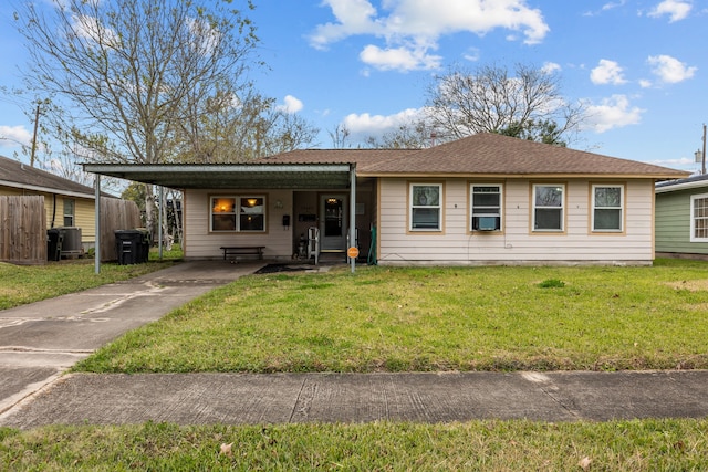 view of front of property with a front yard, a carport, and central AC unit