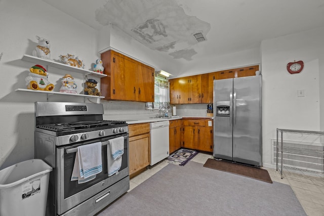 kitchen with sink, decorative backsplash, and appliances with stainless steel finishes