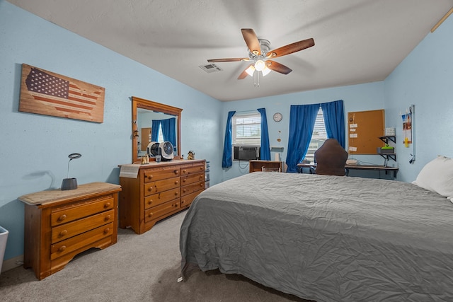 bedroom with ceiling fan, cooling unit, and light carpet