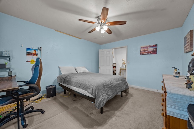 bedroom with ceiling fan and light carpet