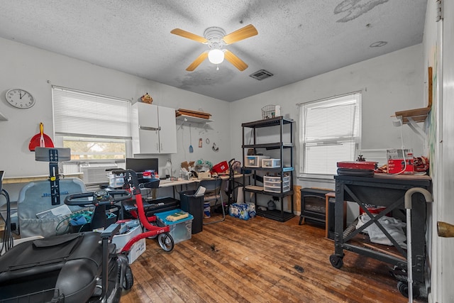 office featuring wood-type flooring, a textured ceiling, and ceiling fan