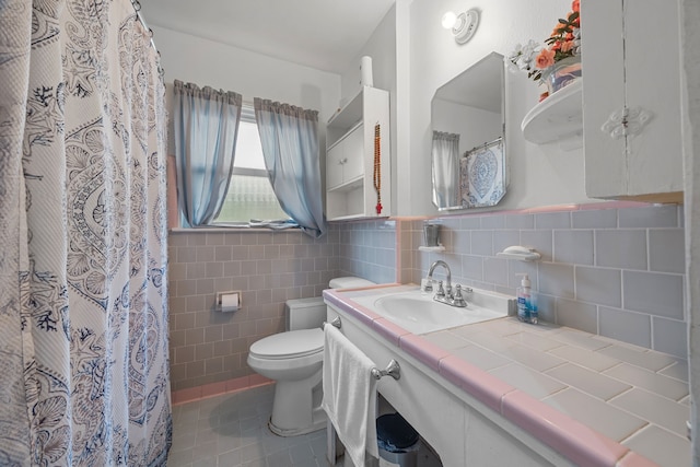 bathroom featuring tile walls, tile patterned flooring, toilet, and vanity