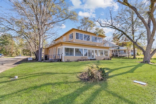 rear view of property with a yard