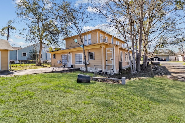 back of house featuring a lawn