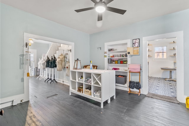 interior space featuring ceiling fan, dark hardwood / wood-style flooring, and built in shelves