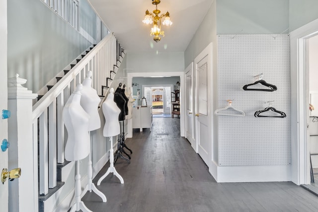 entrance foyer featuring dark hardwood / wood-style flooring and a chandelier