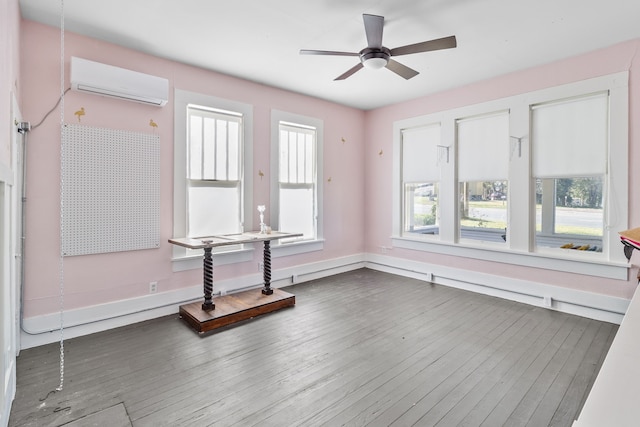 unfurnished room featuring ceiling fan and a wall mounted air conditioner