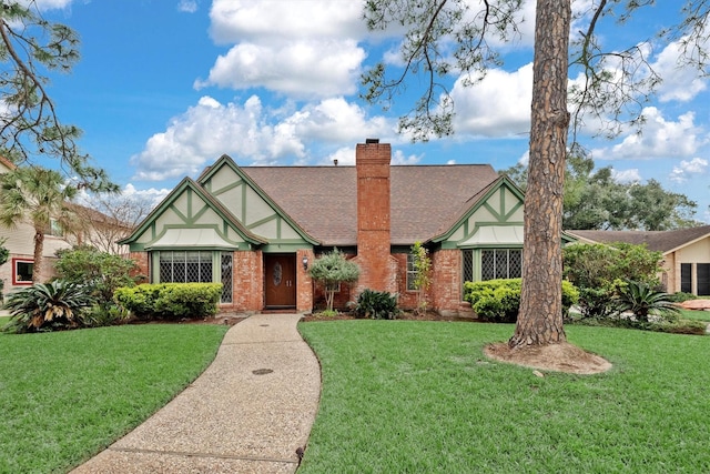 tudor home featuring a front yard