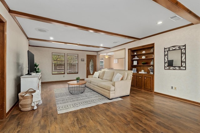 living room with built in shelves, dark wood-type flooring, ceiling fan, and ornamental molding