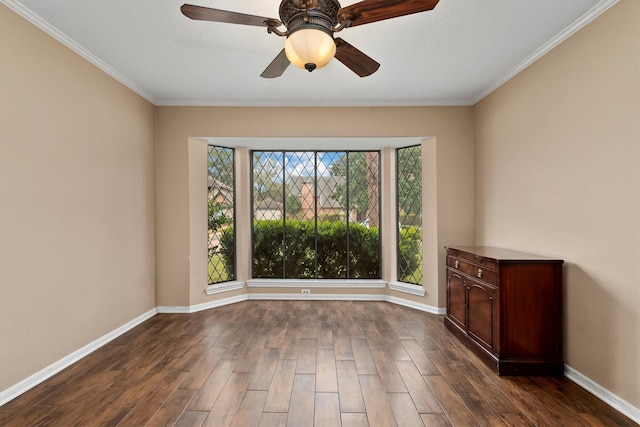 unfurnished room with ceiling fan, dark hardwood / wood-style flooring, and crown molding