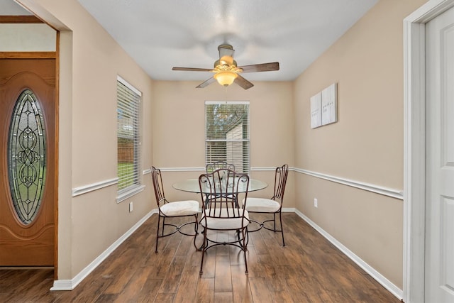 dining area with ceiling fan, a healthy amount of sunlight, and dark hardwood / wood-style floors