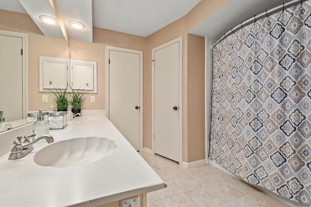 bathroom with vanity, tile patterned floors, and curtained shower