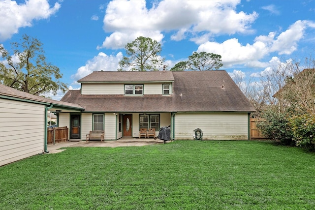 back of property featuring a lawn and a patio area