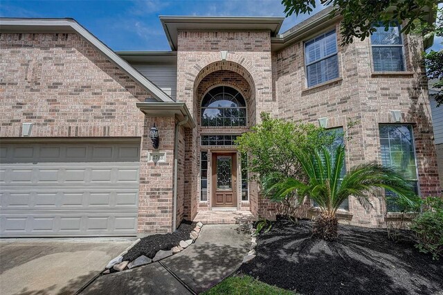 doorway to property with a garage