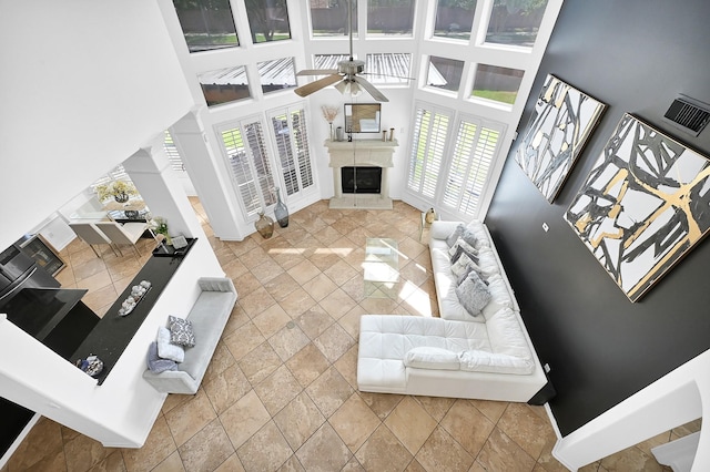 living room featuring a high ceiling and ceiling fan