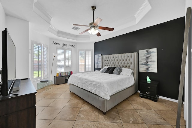 bedroom with ceiling fan, ornamental molding, a raised ceiling, and light tile patterned floors