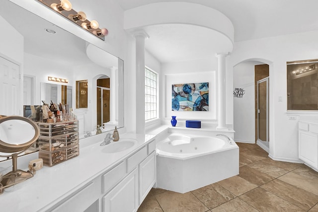 bathroom featuring vanity, shower with separate bathtub, and ornate columns