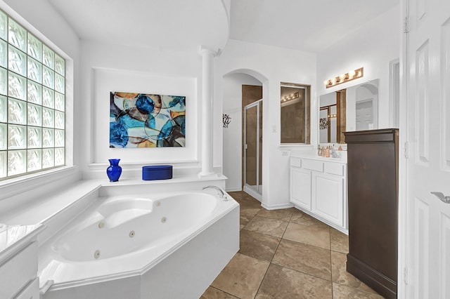 bathroom featuring vanity, separate shower and tub, and decorative columns