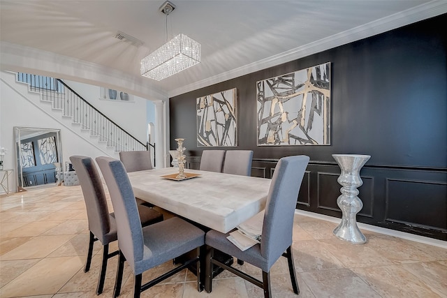 tiled dining area with ornamental molding and a notable chandelier