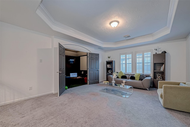 living room with ornamental molding, a raised ceiling, carpet floors, and a textured ceiling