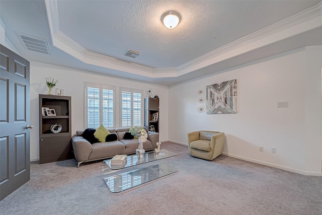 carpeted living room featuring ornamental molding, a tray ceiling, and a textured ceiling