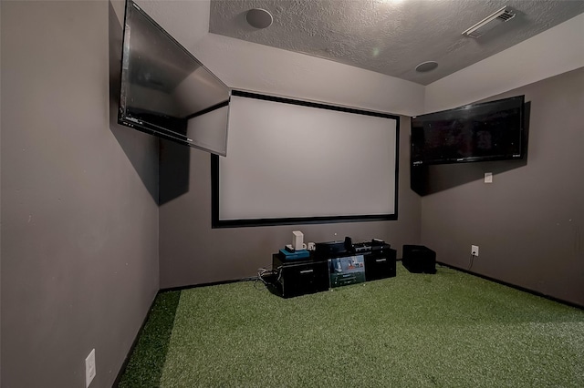 carpeted home theater with a textured ceiling