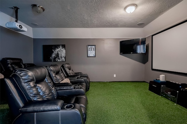 carpeted cinema room featuring a textured ceiling