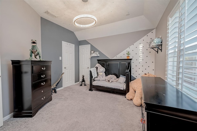 bedroom featuring lofted ceiling and light carpet