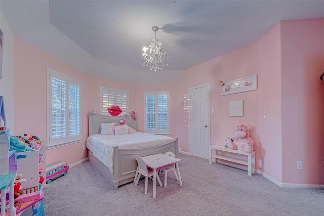 bedroom featuring a raised ceiling, light colored carpet, and an inviting chandelier